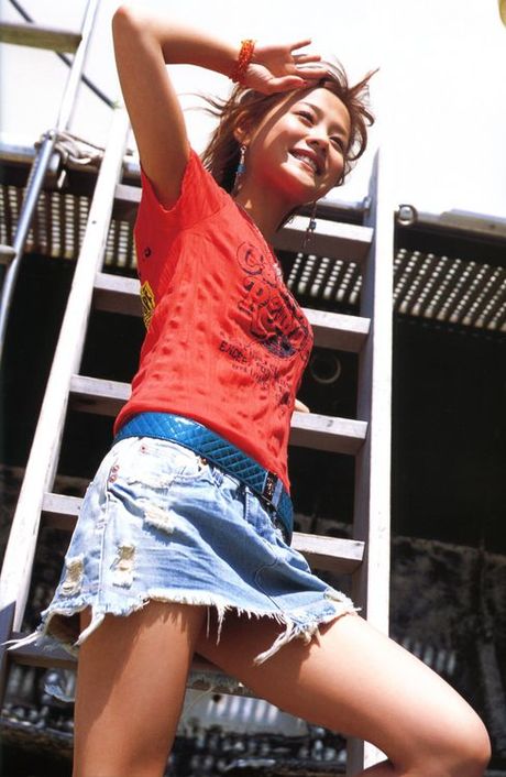 Cute asian girl is flirtatious with her long hair in a dress