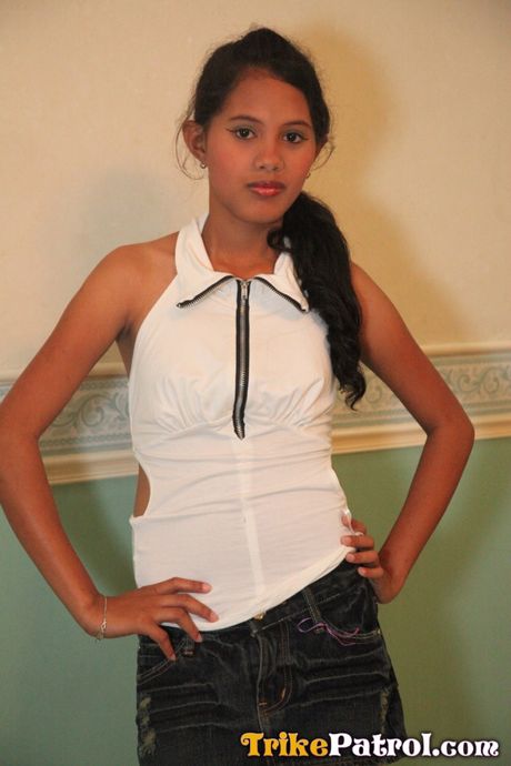 Asian teen Angel strips and shows her tiny tits and pink pussy