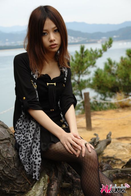 Asian babe Rena strips to her pantyhose and bares it all outdoors