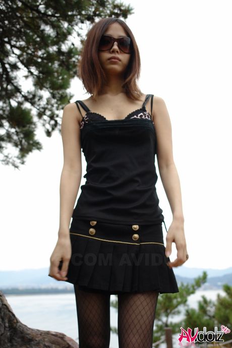 Asian babe Rena strips to her pantyhose and bares it all outdoors